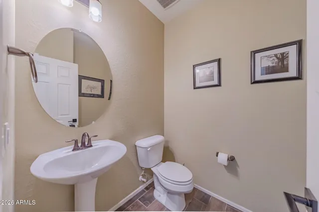 a bathroom with a sink mirror and toilet