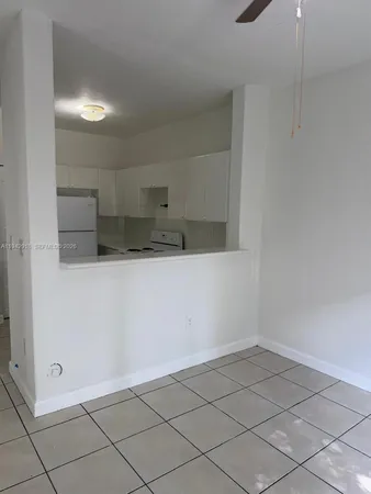a view of a refrigerator and window in a room