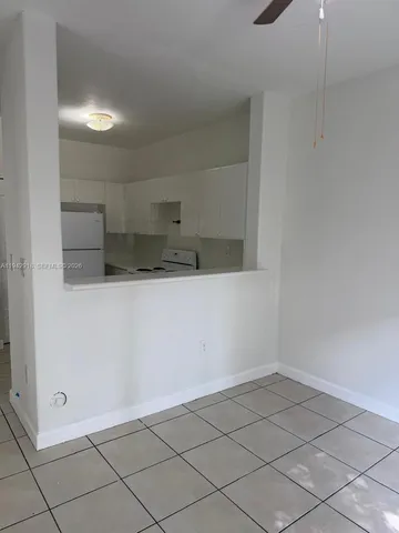a view of a refrigerator and window in a room