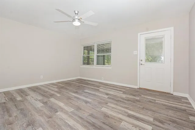 wooden floor in an empty room with a window