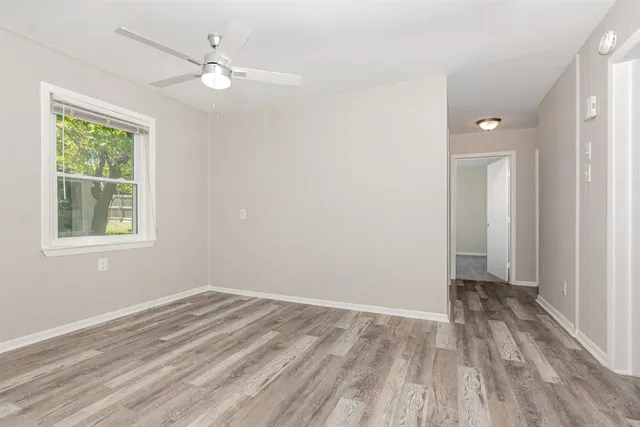 wooden floor in an empty room with a window