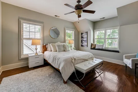 a bedroom with a large bed and a chandelier