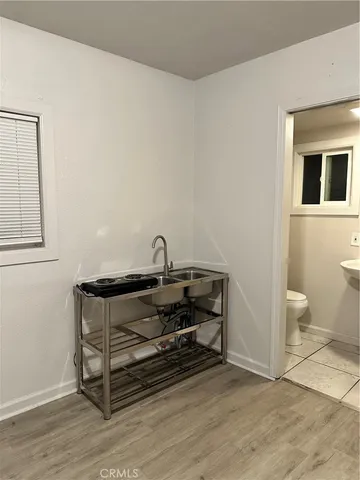 a view of a room with wooden floor and cabinet