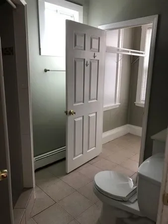 a bathroom with a tub and toilet
