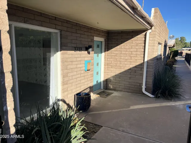 a view of front door and potted plants