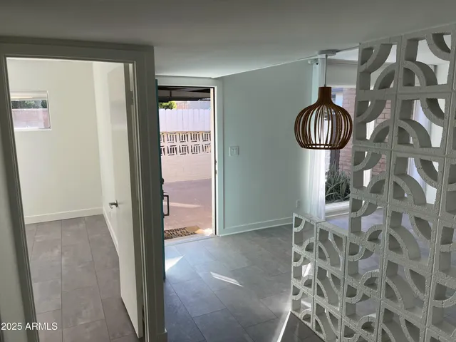 a view of a hallway and wooden shelves