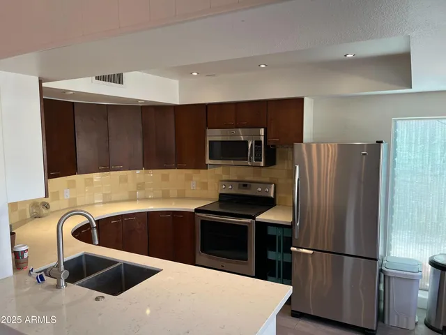a kitchen that has a sink and a stove in it