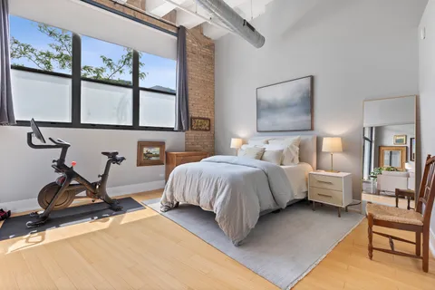 a bedroom with bed and window