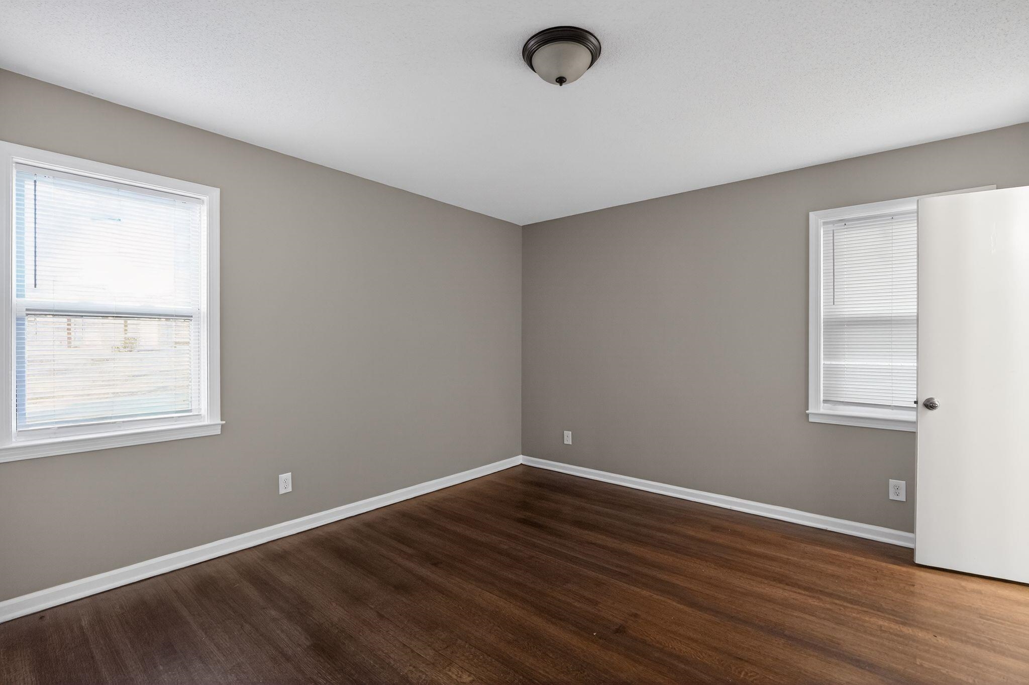 3124 Boone Street Memphis, TN 38127 - Photo 16 of 30 an empty room with wooden floor and windows