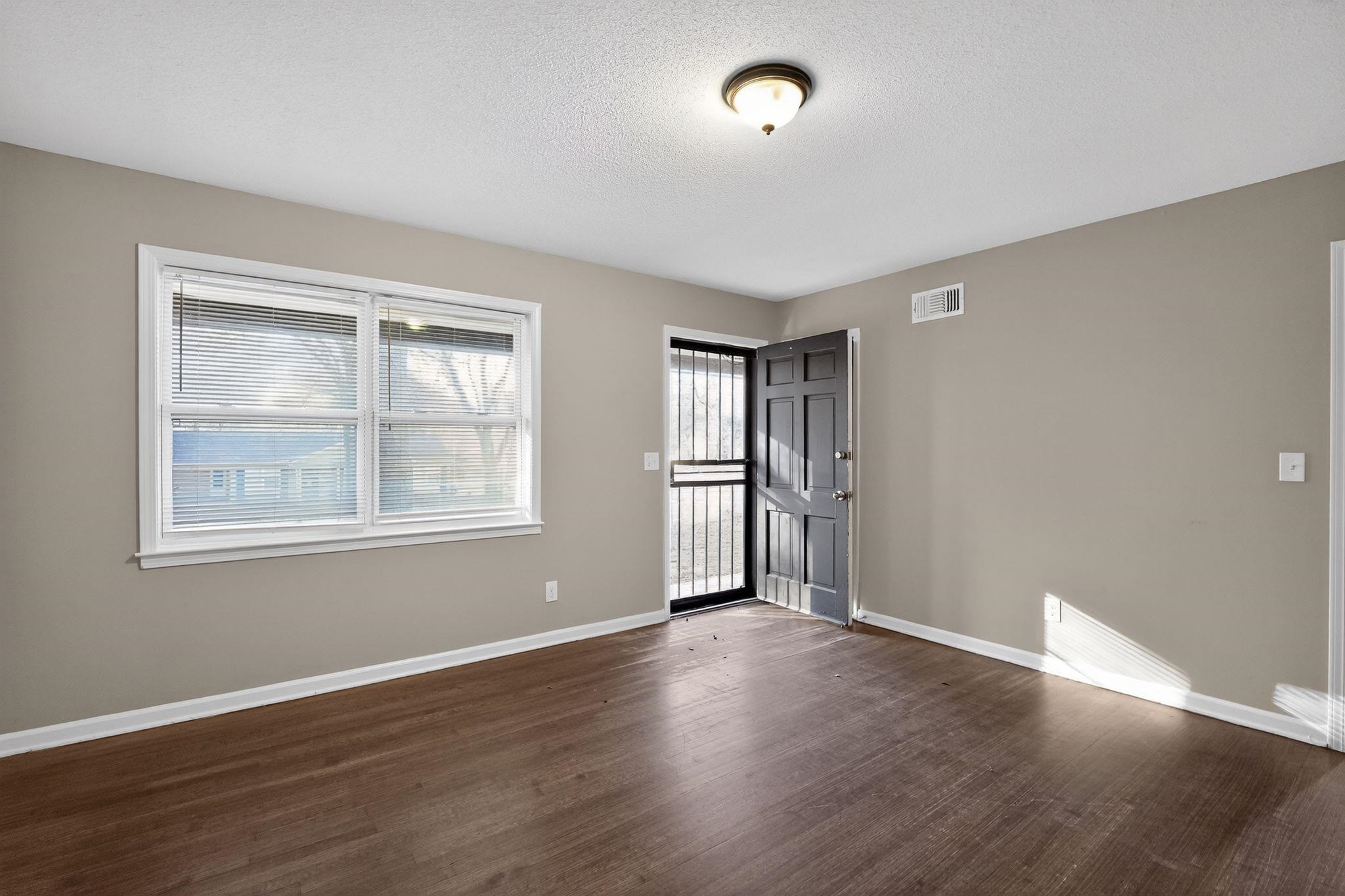 3124 Boone Street Memphis, TN 38127 - Photo 17 of 30 an empty room with wooden floor and windows