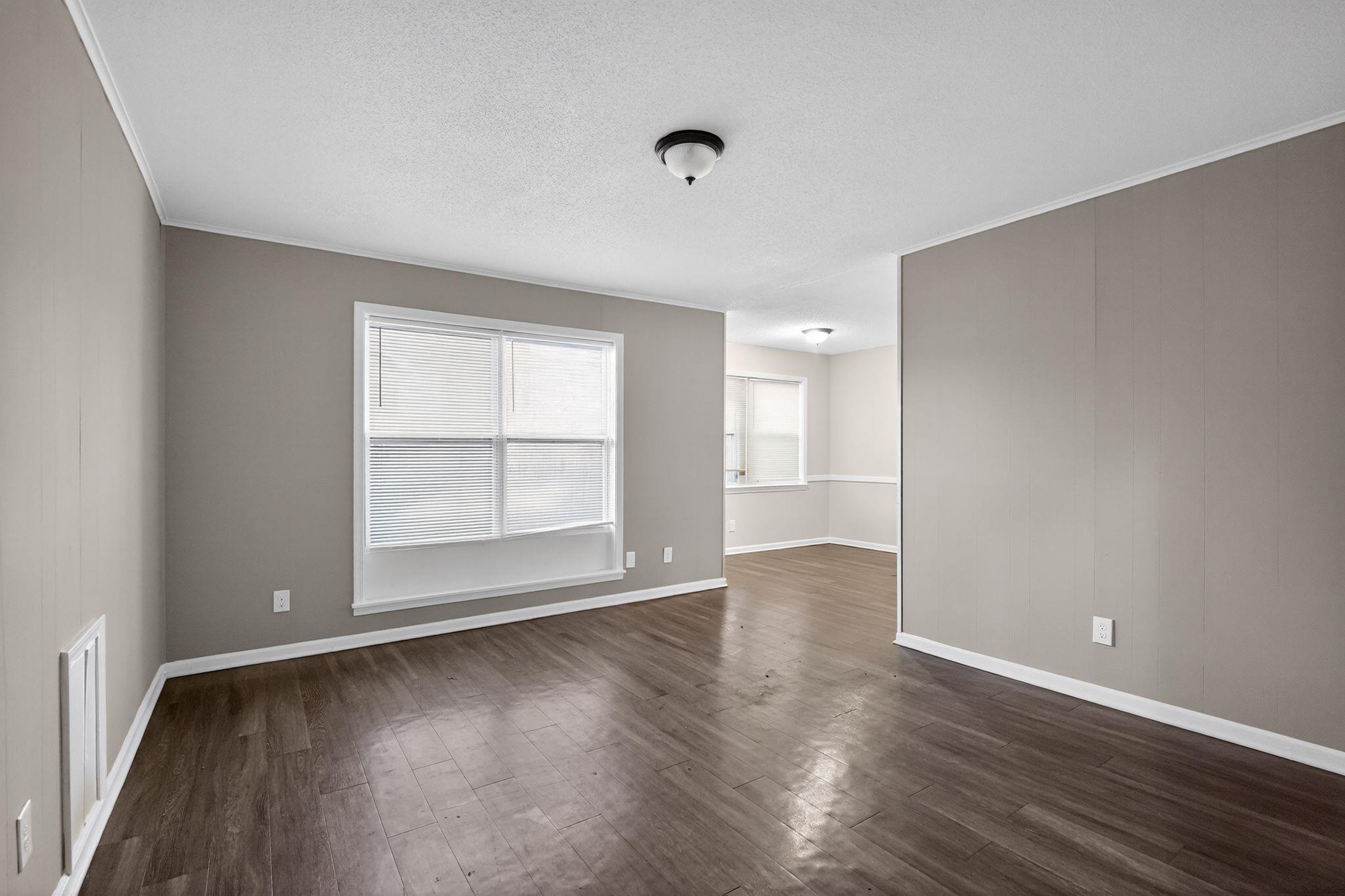 3124 Boone Street Memphis, TN 38127 - Photo 2 of 30 an empty room with wooden floor and windows