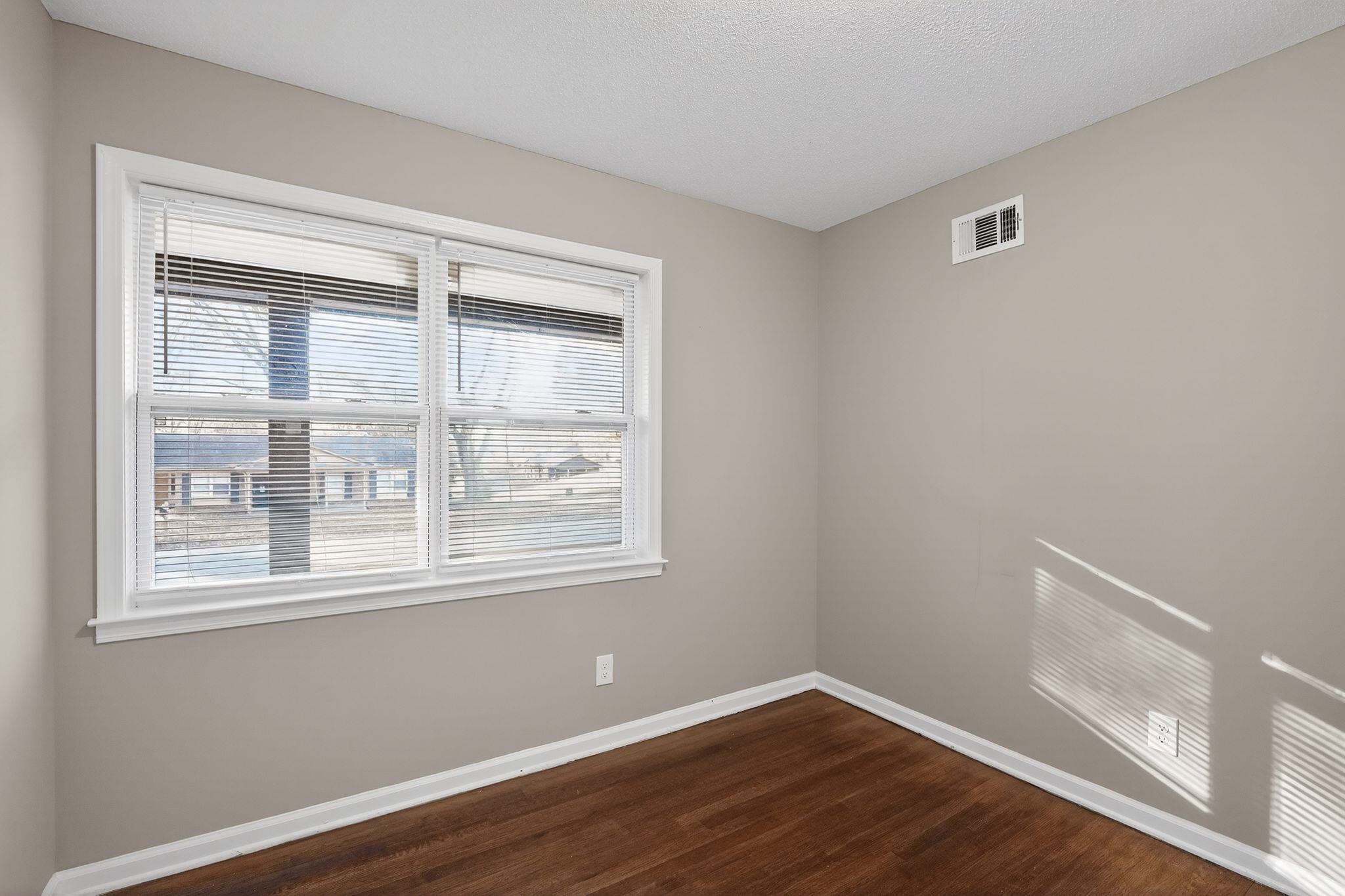 3124 Boone Street Memphis, TN 38127 - Photo 22 of 30 a view of an empty room with wooden floor and a window