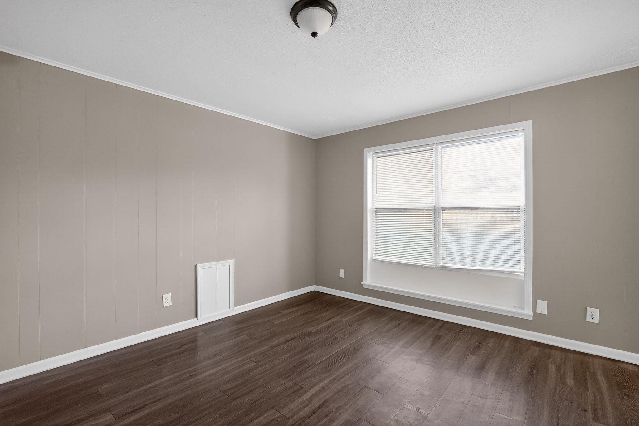 3124 Boone Street Memphis, TN 38127 - Photo 23 of 30 an empty room with wooden floor and windows