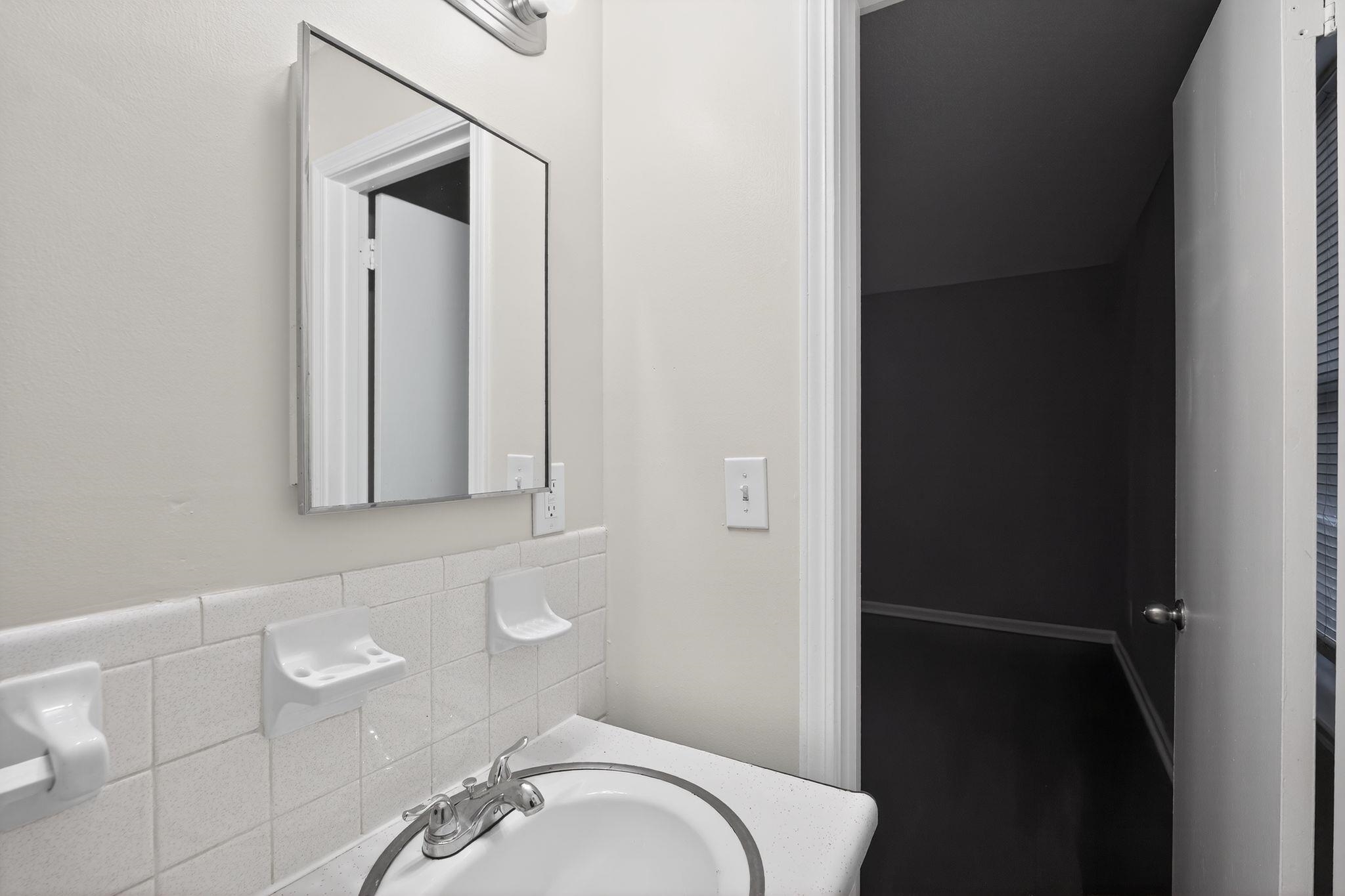 3124 Boone Street Memphis, TN 38127 - Photo 25 of 30 a bathroom with a granite countertop sink and a mirror