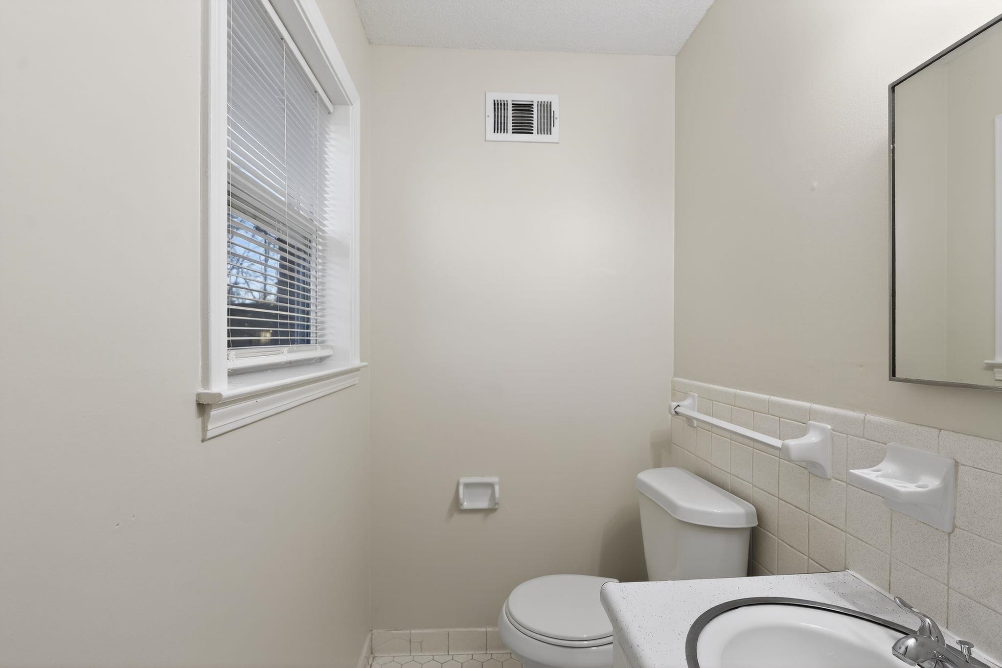 3124 Boone Street Memphis, TN 38127 - Photo 26 of 30 a white toilet sitting next to a bathroom sink
