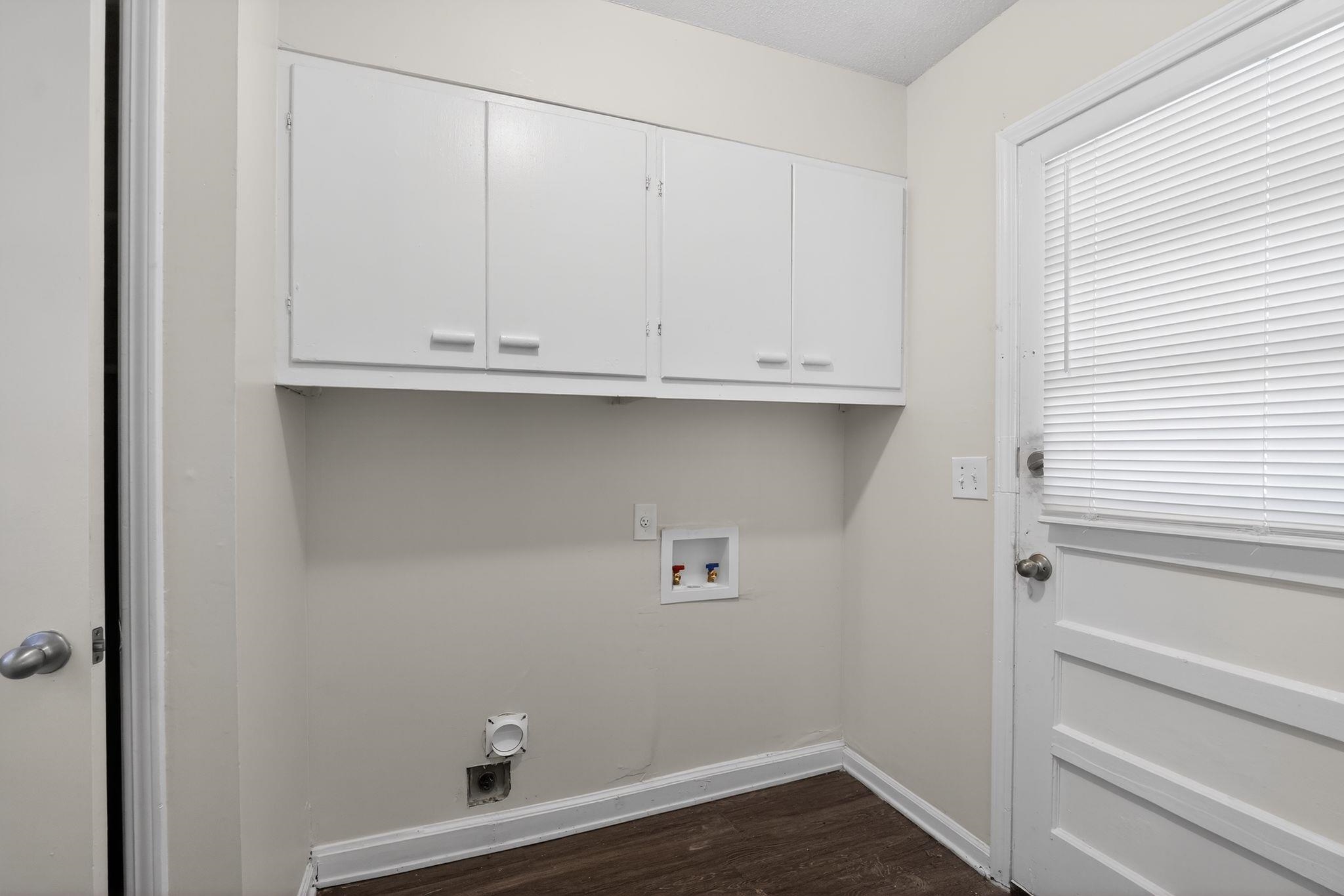 3124 Boone Street Memphis, TN 38127 - Photo 28 of 30 Laundry area featuring washer hookup, cabinet space, and dark wood-type flooring