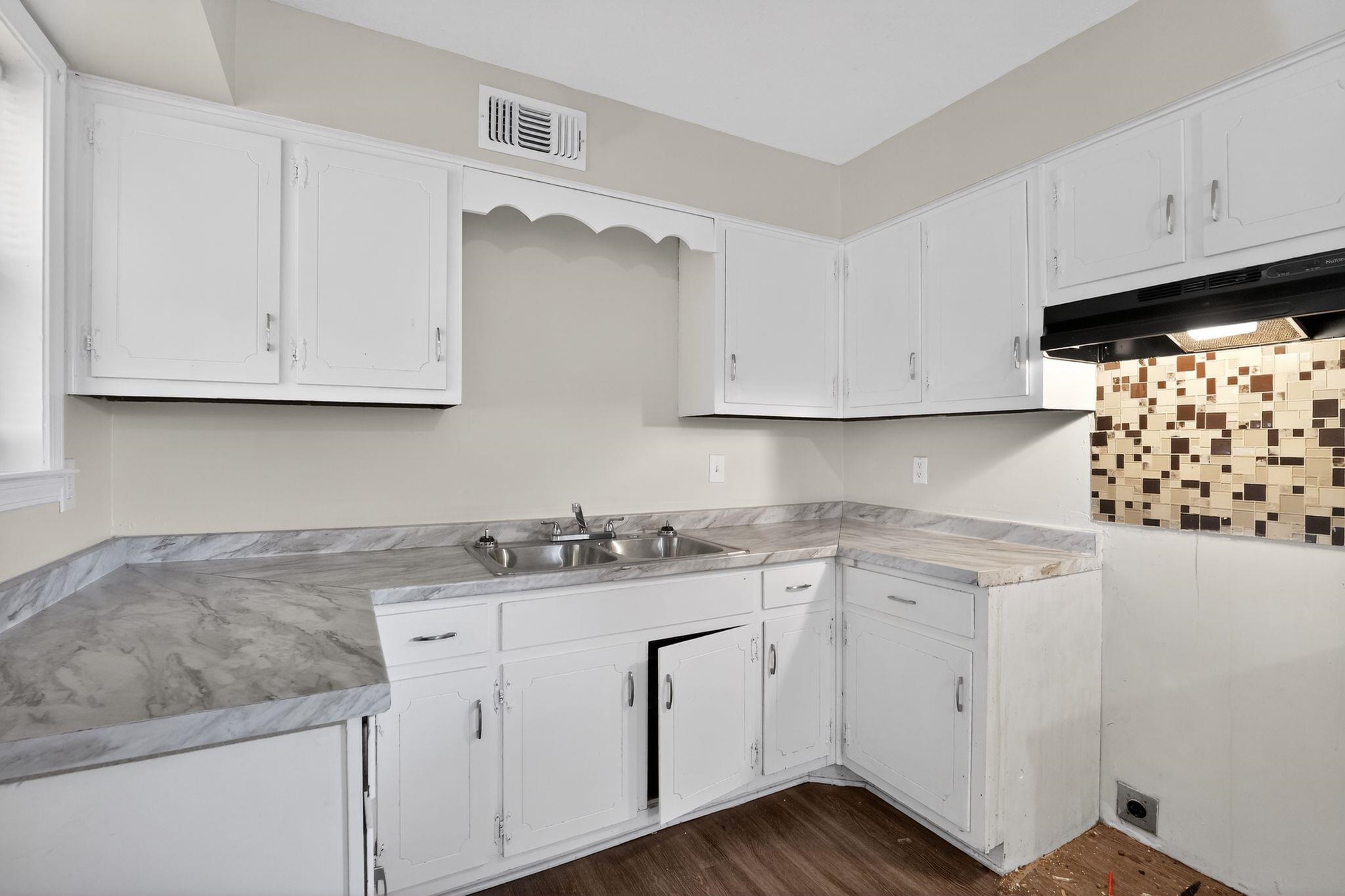 3124 Boone Street Memphis, TN 38127 - Photo 3 of 30 a kitchen with stainless steel appliances granite countertop white cabinets sink and dishwasher