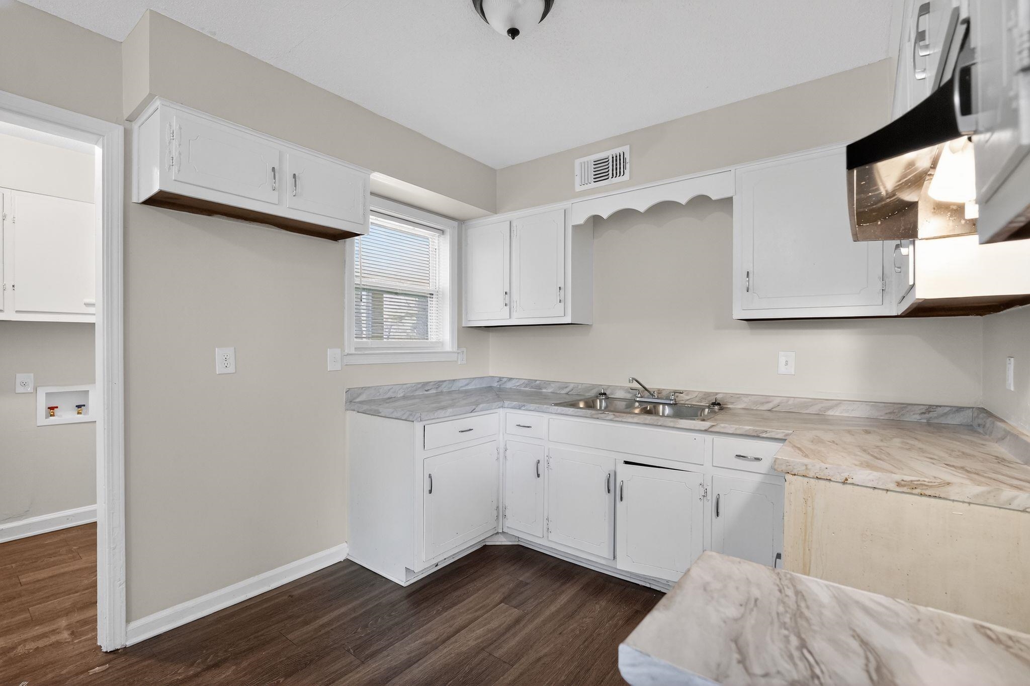3124 Boone Street Memphis, TN 38127 - Photo 5 of 30 a kitchen with granite countertop a sink cabinets and wooden floor
