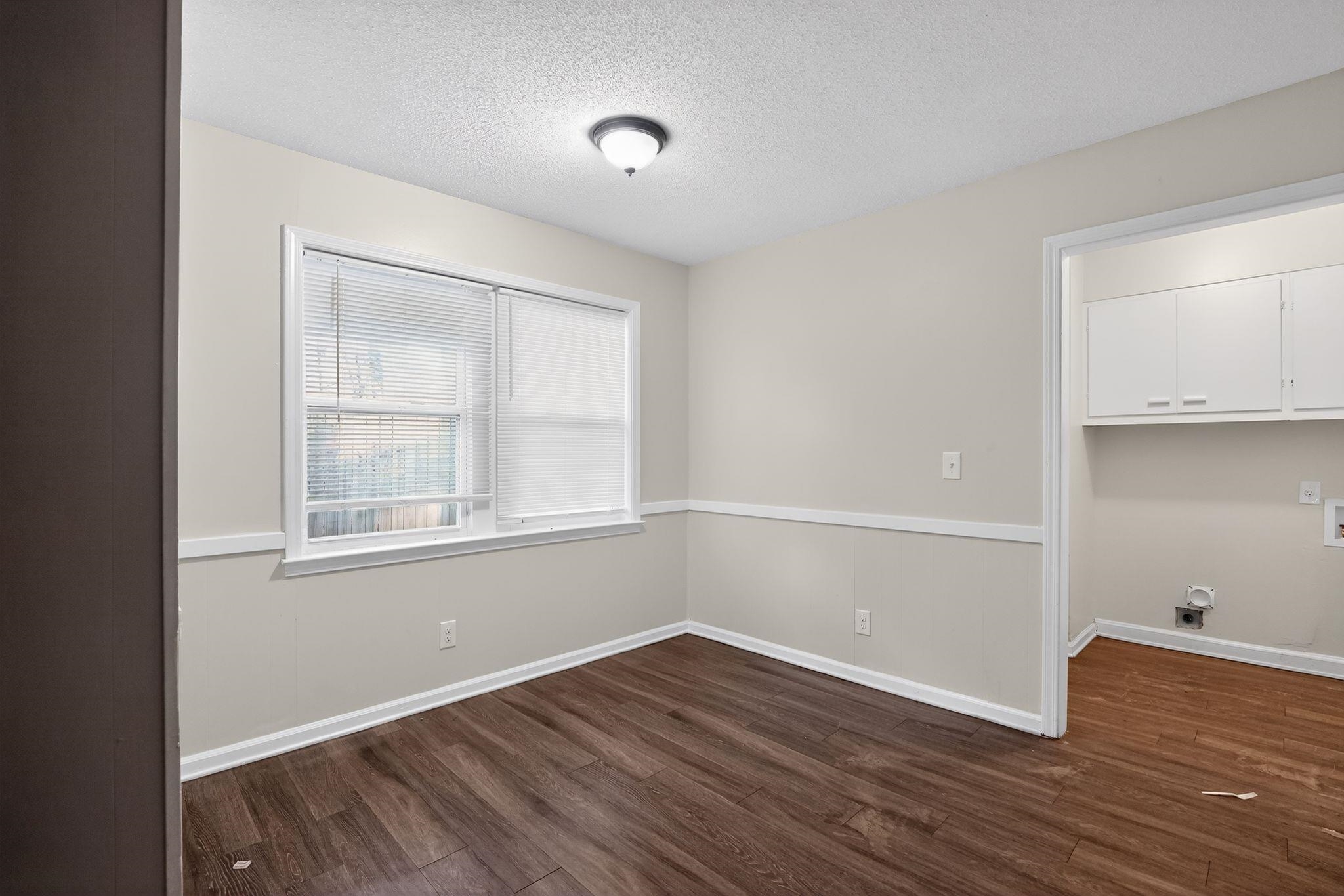 3124 Boone Street Memphis, TN 38127 - Photo 7 of 30 a view of an empty room with wooden floor and a window