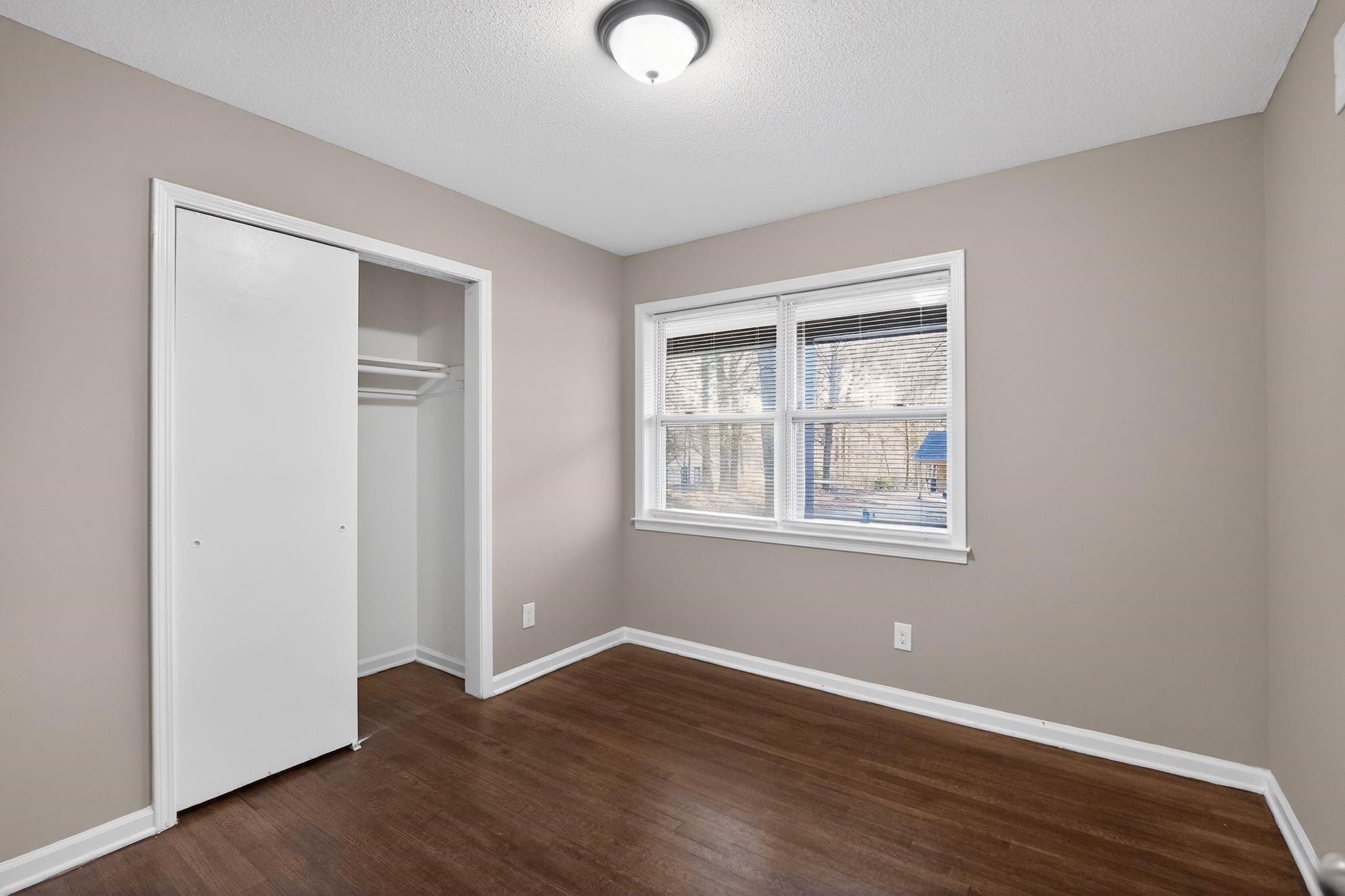 3124 Boone Street Memphis, TN 38127 - Photo 8 of 30 a view of an empty room with wooden floor and a window