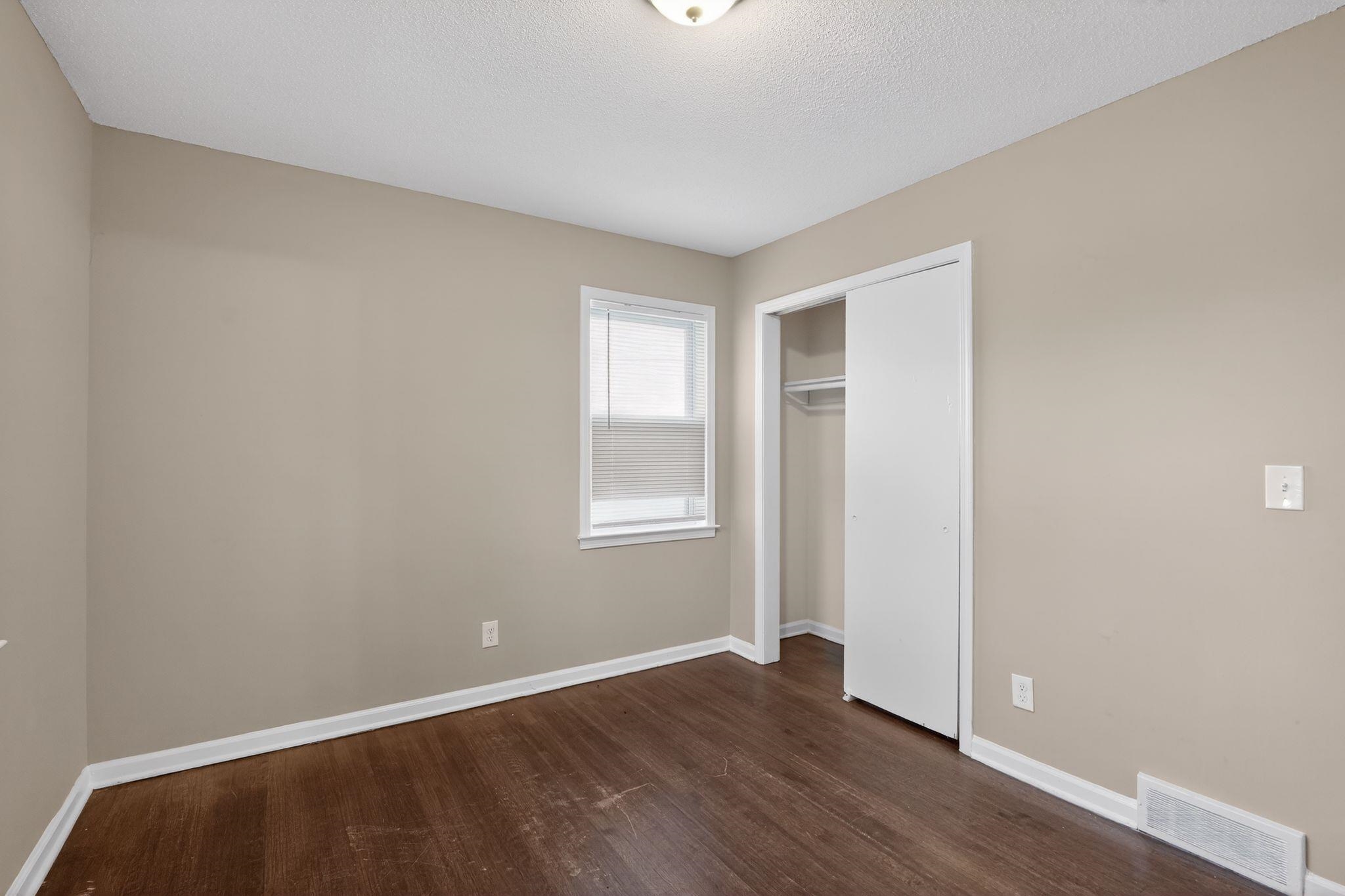 3124 Boone Street Memphis, TN 38127 - Photo 10 of 30 an empty room with wooden floor and windows