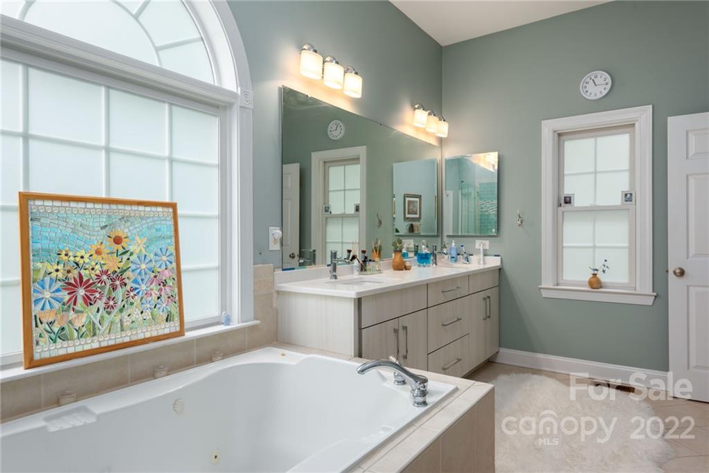 8804 Brentfield Road Huntersville, NC 28078 - Photo 30 of 39 a bathroom with a tub sink shower and mirror