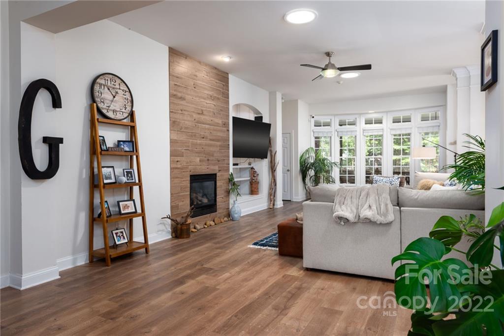 8804 Brentfield Road Huntersville, NC 28078 - Photo 6 of 39 a living room with fireplace furniture and a large window