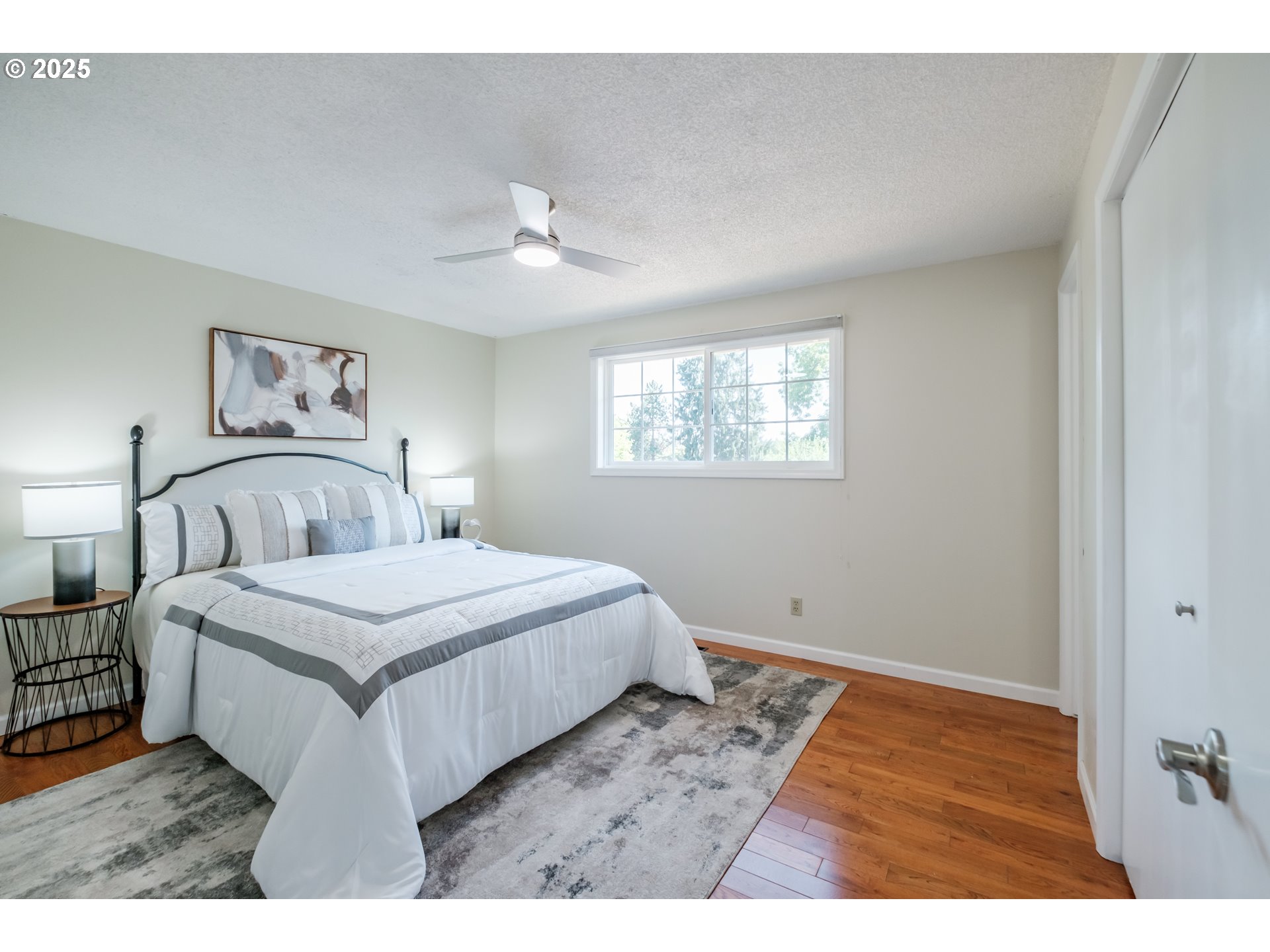 2040 Northwest 23rd Street Corvallis, OR 97330 - Photo 24 of 48 a bedroom with a large bed and a chandelier