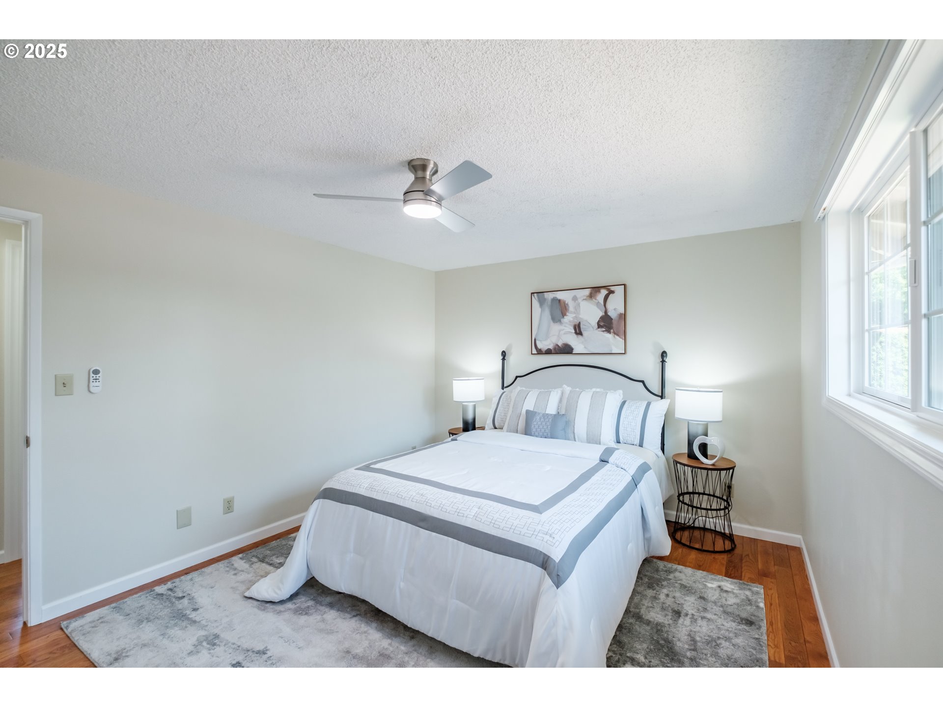 2040 Northwest 23rd Street Corvallis, OR 97330 - Photo 25 of 48 a bedroom with a bed and a chandelier