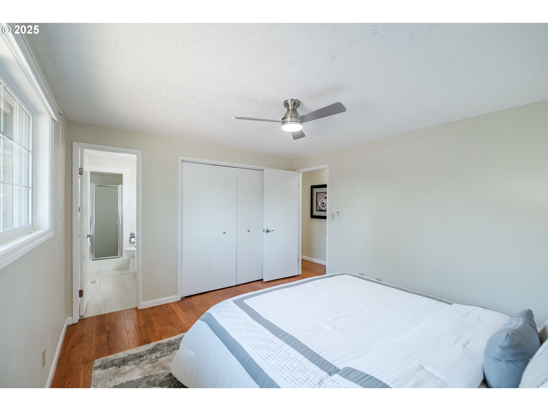 2040 Northwest 23rd Street Corvallis, OR 97330 - Photo 26 of 48 a bedroom with a bed and a chandelier