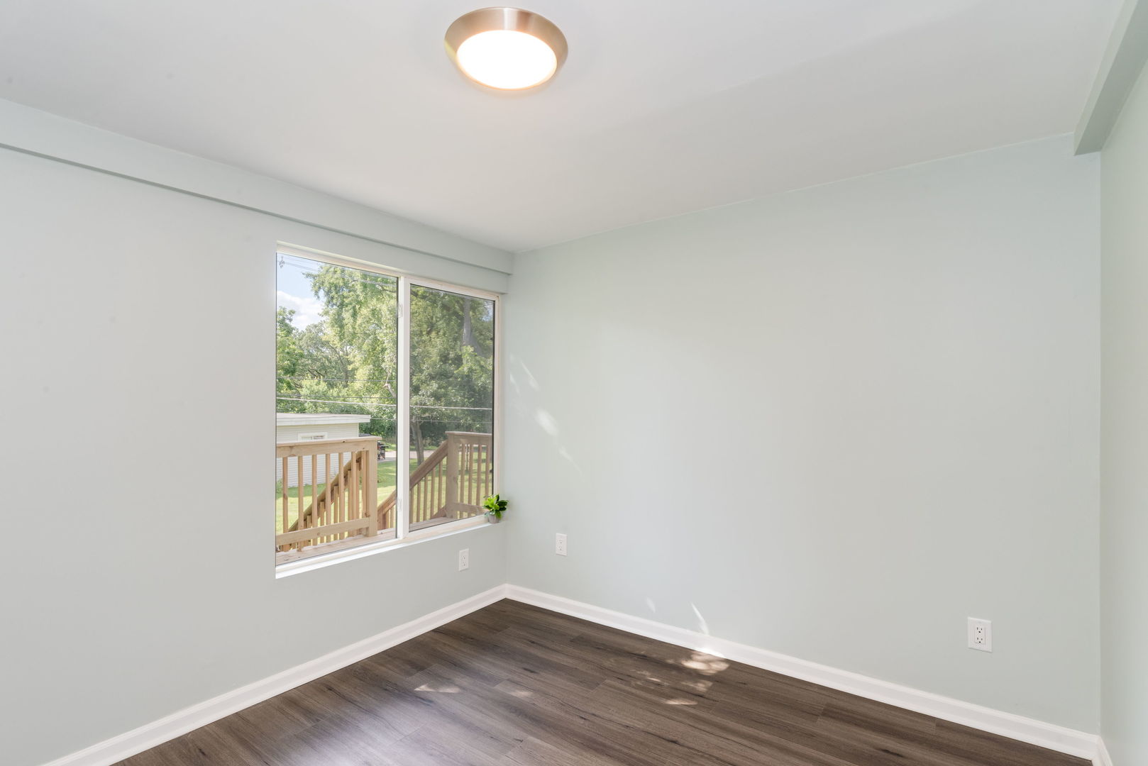 3821 East Wonder Lake Road Wonder Lake, IL 60097 - Photo 13 of 28 a view of an empty room with wooden floor and a window