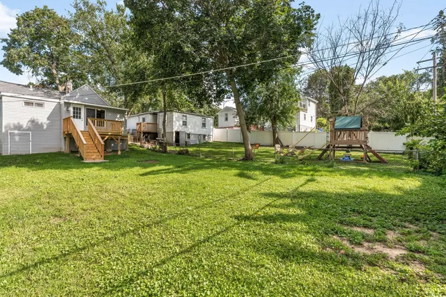 a view of a house with backyard and sitting area