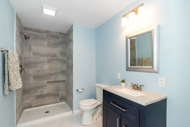 a bathroom with a sink toilet and shower