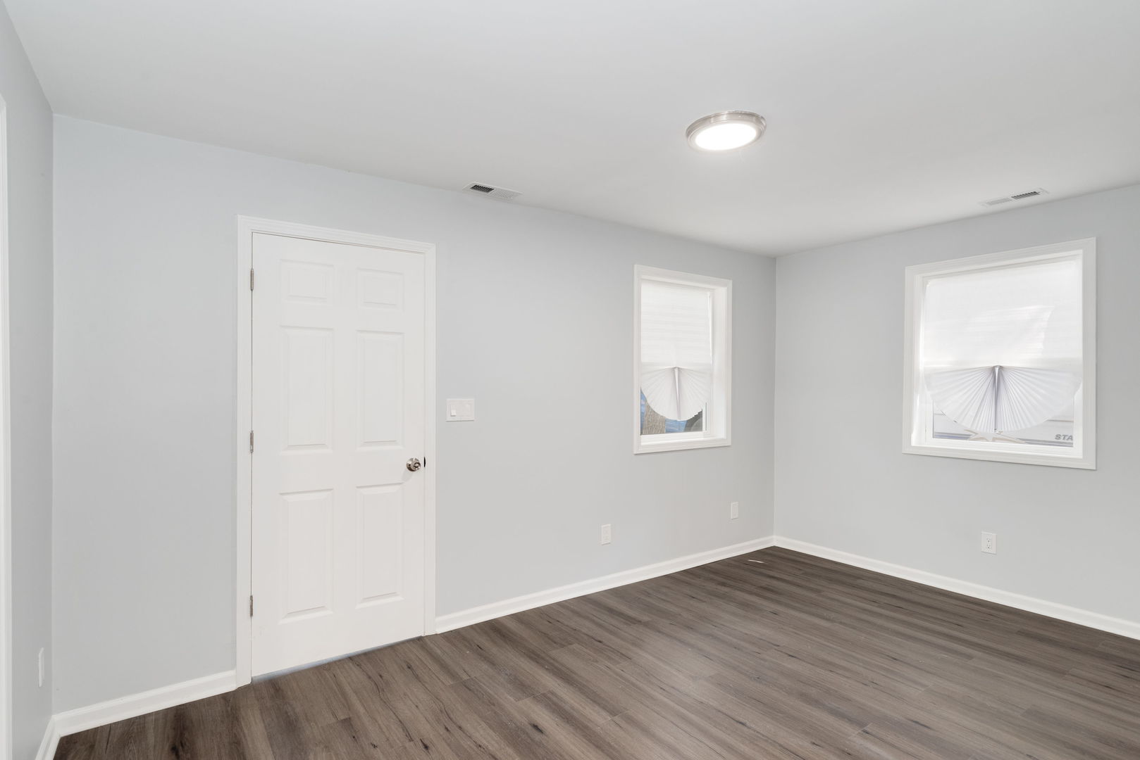 3821 East Wonder Lake Road Wonder Lake, IL 60097 - Photo 7 of 28 an empty room with wooden floor and windows