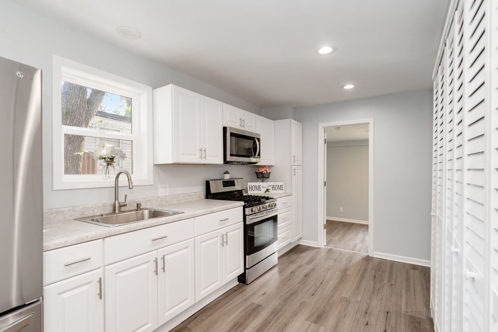 3821 East Wonder Lake Road Wonder Lake, IL 60097 - Photo 9 of 28 a kitchen with sink a microwave and cabinets