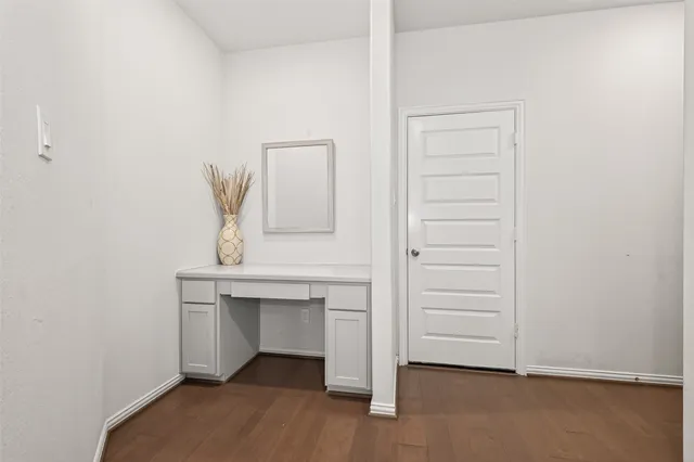 a view of a livingroom with furniture white walls and windows