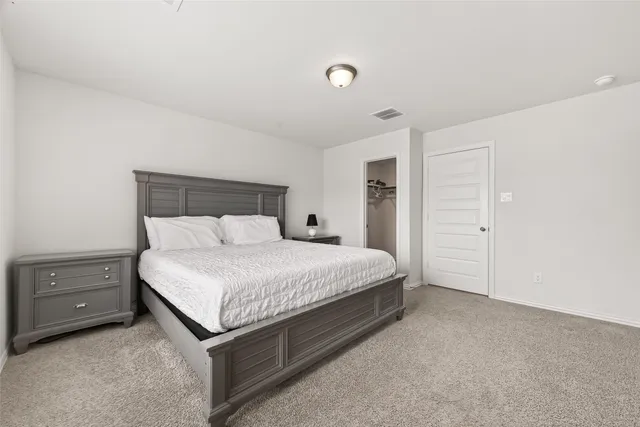 a large white bed in a white room