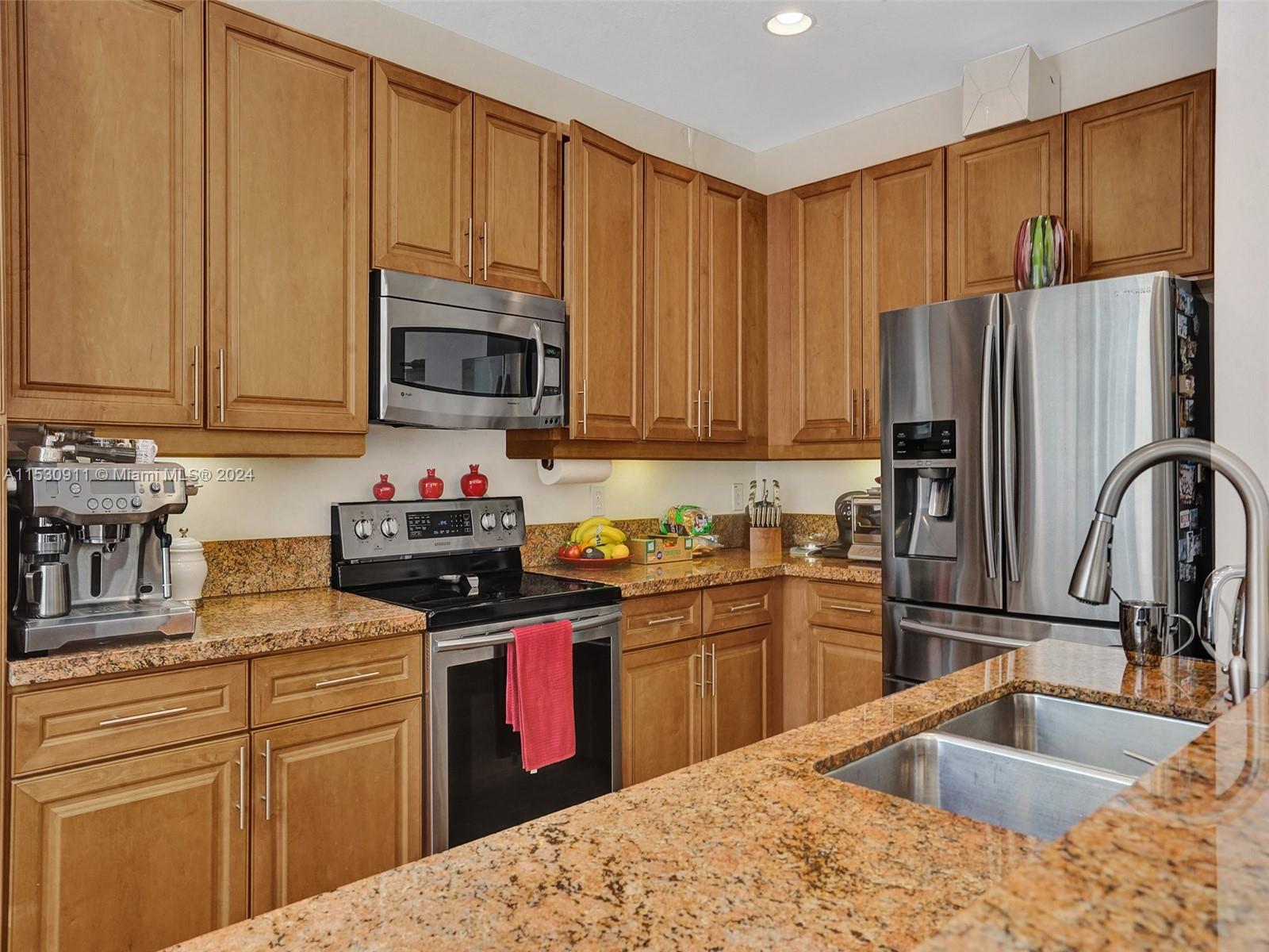 3630 Northwest 5th Terrace, Unit 3630 Boca Raton, FL 33431 - Photo 16 of 31 a kitchen with kitchen island granite countertop a sink stainless steel appliances and cabinets