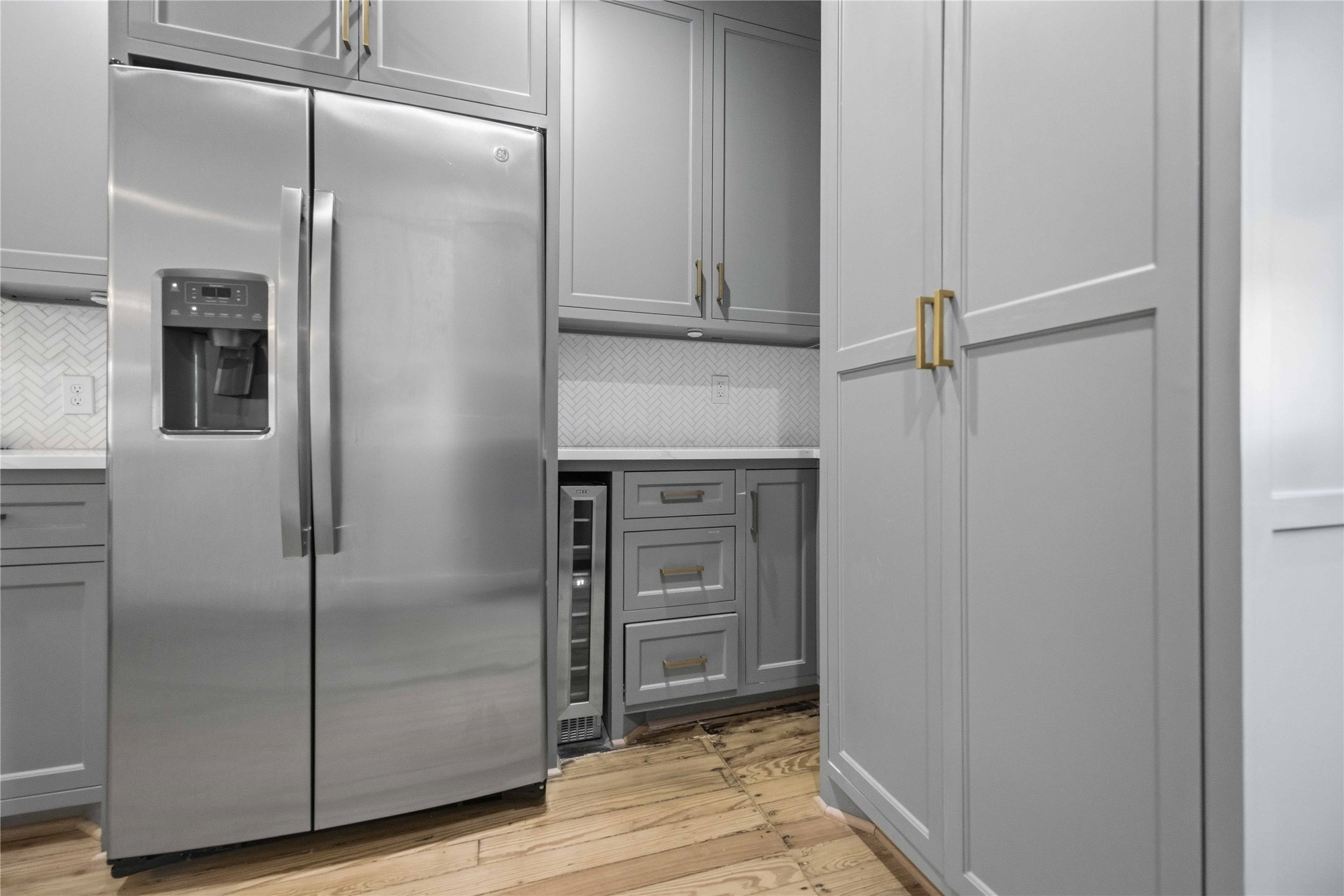 208 Archer Street Houston, TX 77009 - Photo 13 of 26 Side-by-side stainless steel refrigerator plus a beverage cooler.