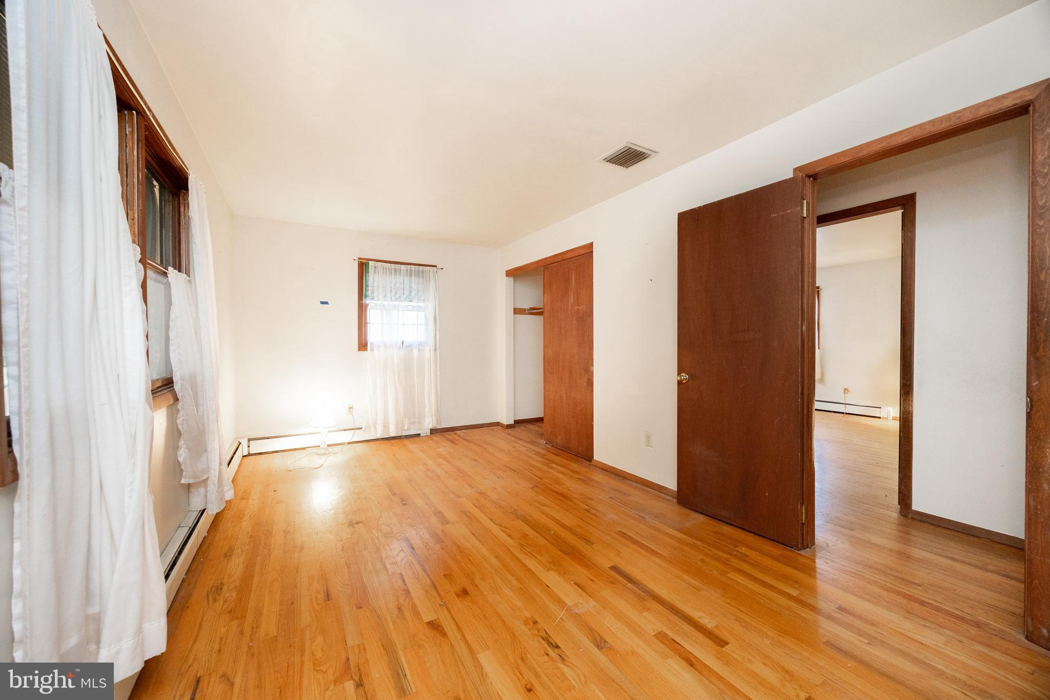 741 Haines Mill Road West Chester, PA 19382 - Photo 14 of 25 a view of an empty room with wooden floor and a window