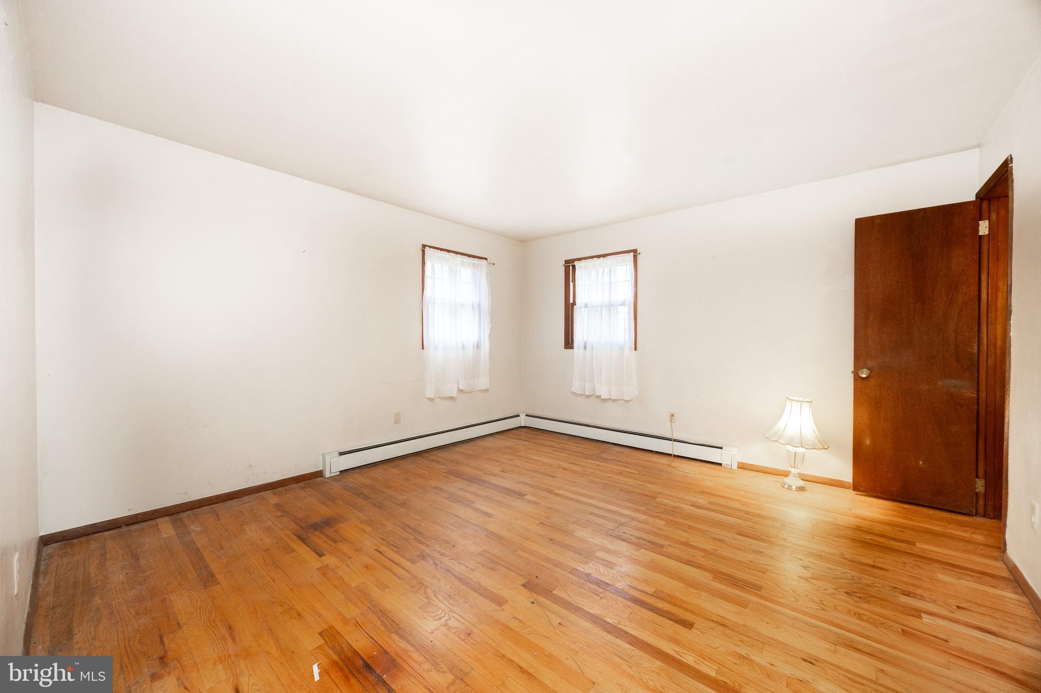 741 Haines Mill Road West Chester, PA 19382 - Photo 15 of 25 an empty room with wooden floor and windows