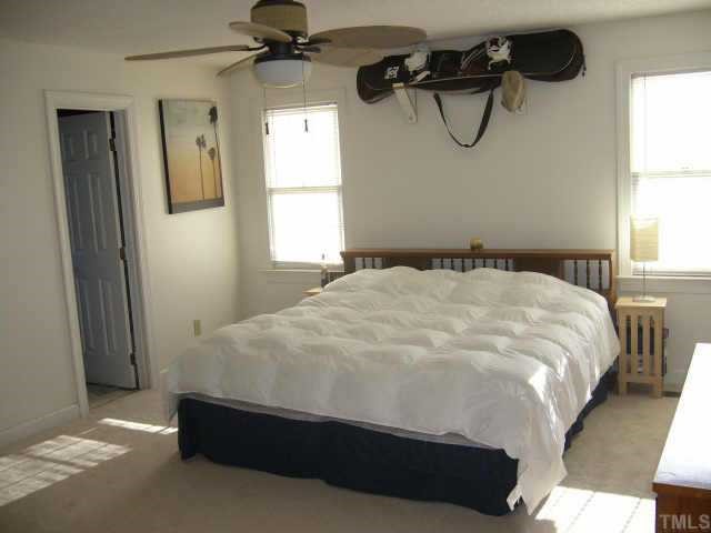 6008 Swales Way Raleigh, NC 27603 - Photo 6 of 11 a bedroom with a bed and a window