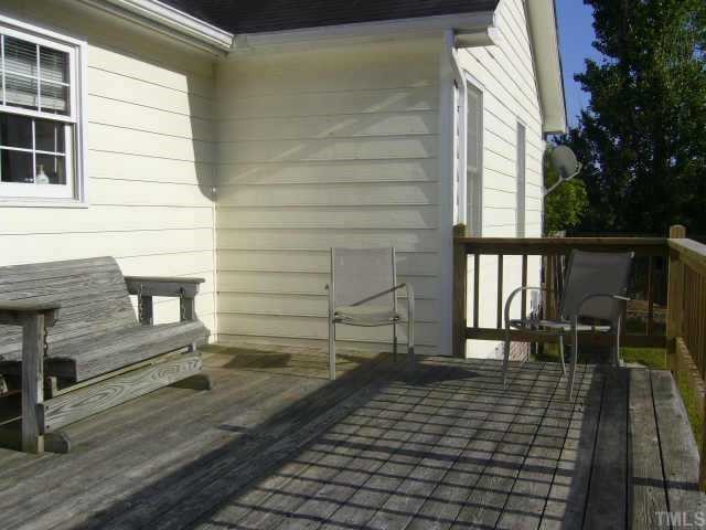 6008 Swales Way Raleigh, NC 27603 - Photo 10 of 11 a porch with a bench next to a yard