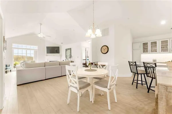 a view of a dining room with furniture and chandelier