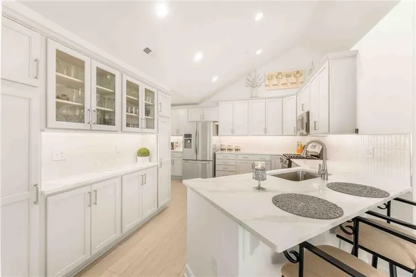 a kitchen with sink and center island