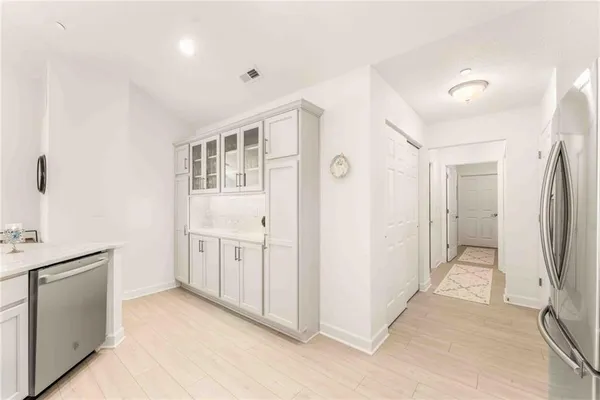 a view of a kitchen with white cabinets