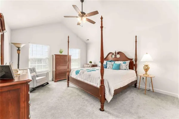 a bed room with a bed window and walk in closet