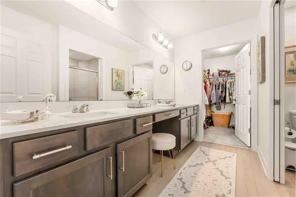 a spacious bathroom with a sink double vanity and a mirror