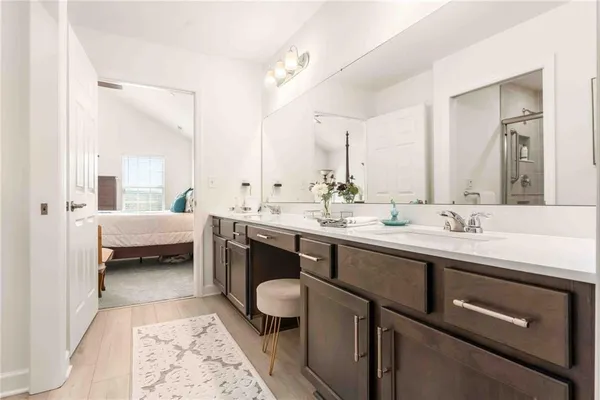 a en suite bathroom with a double vanity sink mirror and