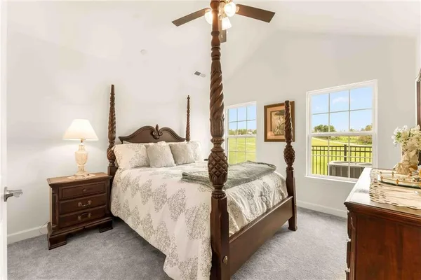 a bedroom with bed and a night stand